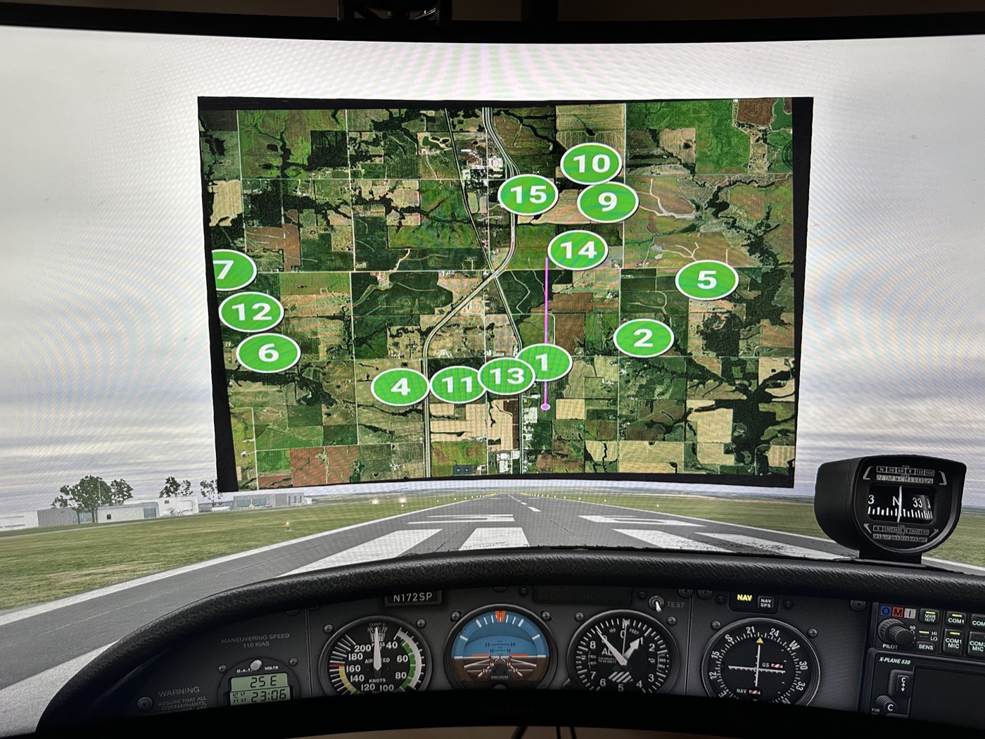 An X-Plane 12 cockpit on a wraparound sim screen, with ReFly's numbered candidate fields painted onto the satellite ground overlay ahead of the runway.